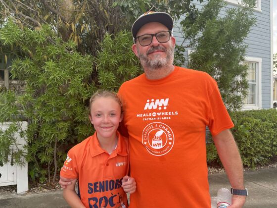 Victoria Nolan stands beside her father after crossing the finish line first in the child division of the 5K at the Meals on Wheels Turkey Trot.