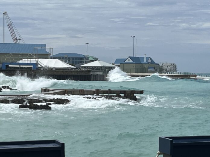 In this file photo, waves hit the George Town harbour area. - Photo: Simon Boxall