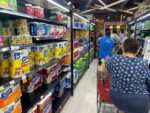 Soaring food and healthcare costs challenge Cayman families Shoppers faced long grocery store lines in preparation for Rafael's arrival. Many were unable to pay for their emergency items due to system outages. - Photo: Sarah Bridge