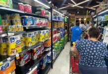 Soaring food and healthcare costs challenge Cayman families Shoppers faced long grocery store lines in preparation for Rafael's arrival. Many were unable to pay for their emergency items due to system outages. - Photo: Sarah Bridge