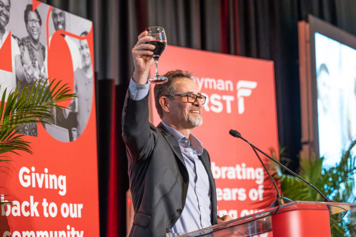 (i) Cayman First Chief Executive Officer, Mr. Chris Hind, makes a toast to the company’s 40 years of service