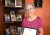 Cayman’s only living national hero passes away, aged 97 Francine A. Jackson, standing next to her display of photos of her grandchildren at her West Bay home, shows her letter affirming her status as Cayman's new National Hero. - Photo: Reshma Ragoonath