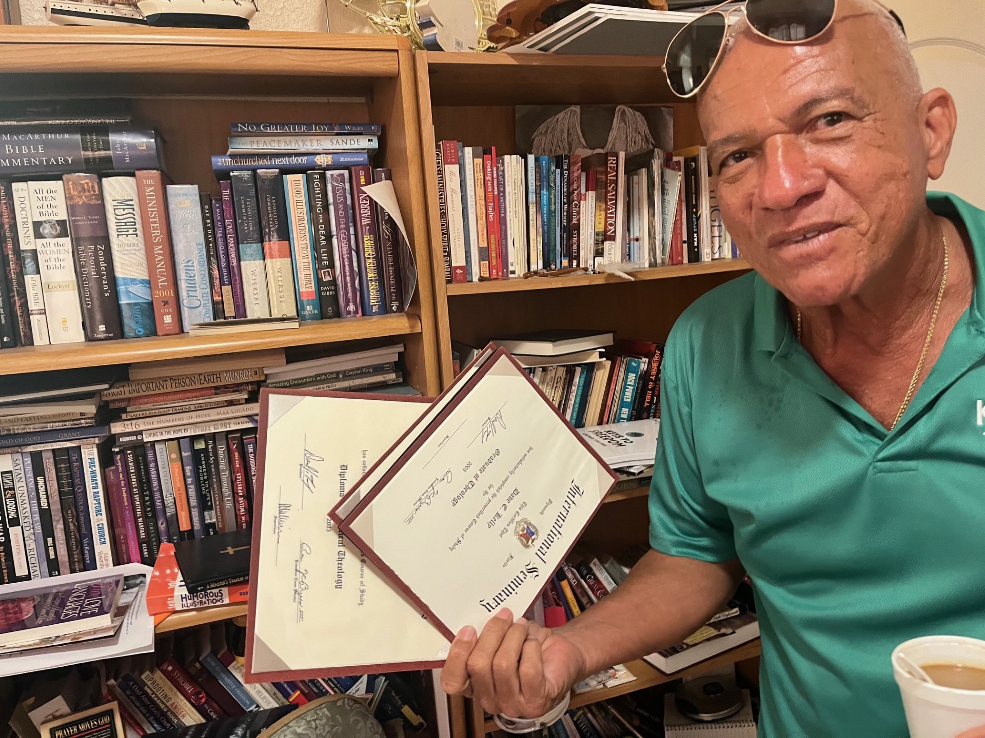 Dave Kelly shows the certificates he received while training to become a preacher. His faith helped him recover from addiction.