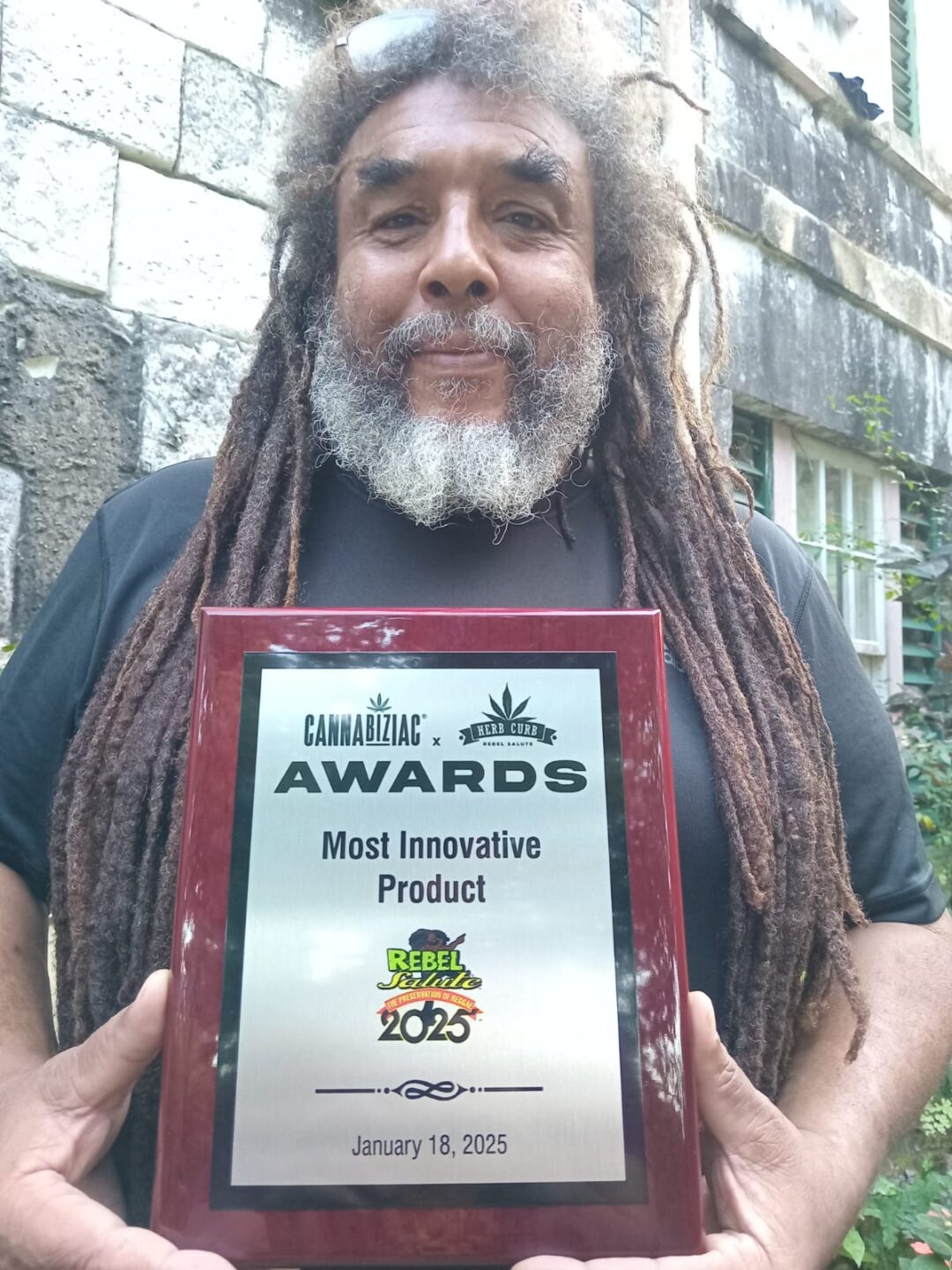 Chris Nixon displays his award at his Lion's Gardens display at the Rebel Salute event in Jamaica. - Photo: Submitted
