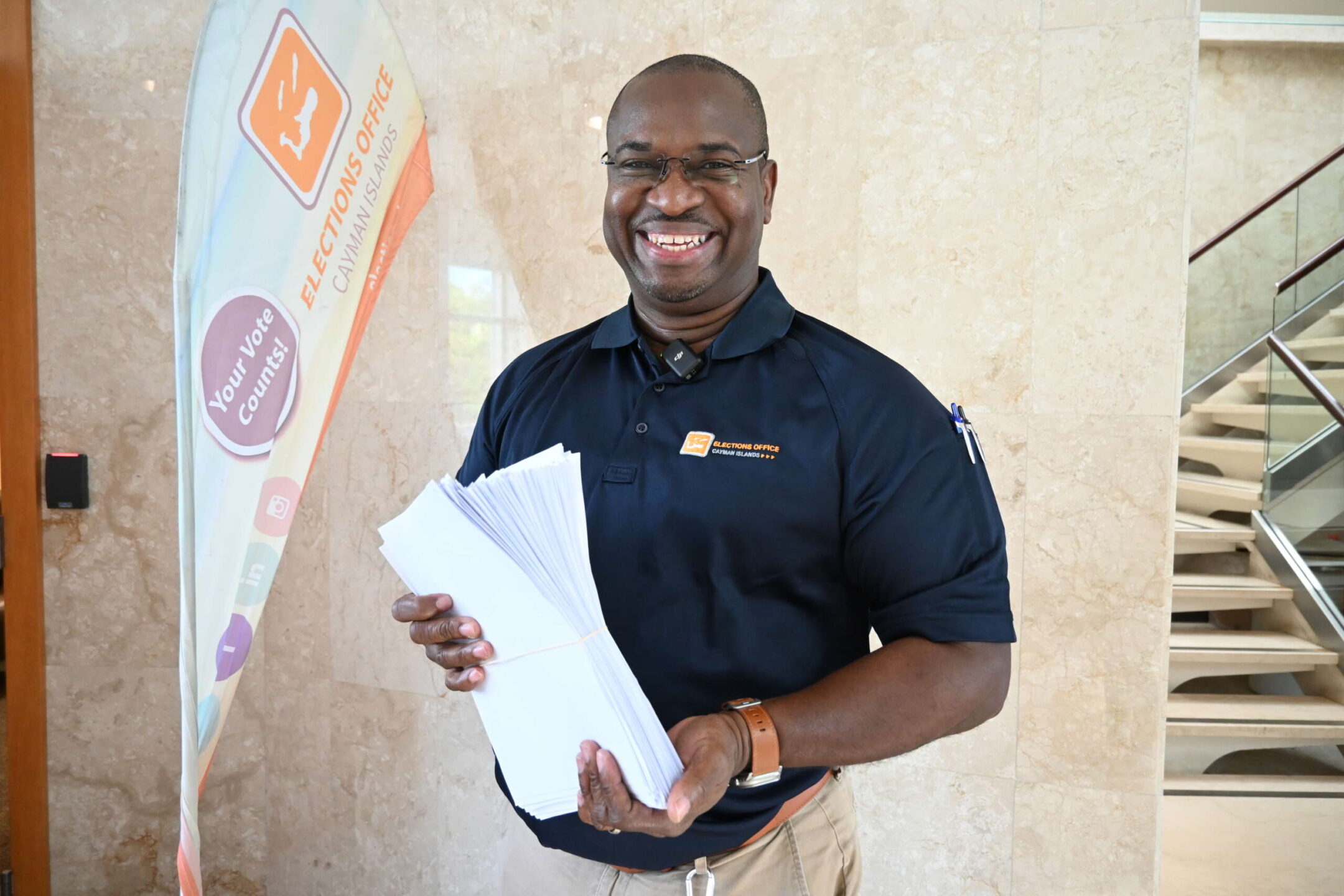 Election Supervisor Wesley Howell shows the bundle of registration forms his team received before lunch on Wednesday. - Photo: Reshma Ragoonath