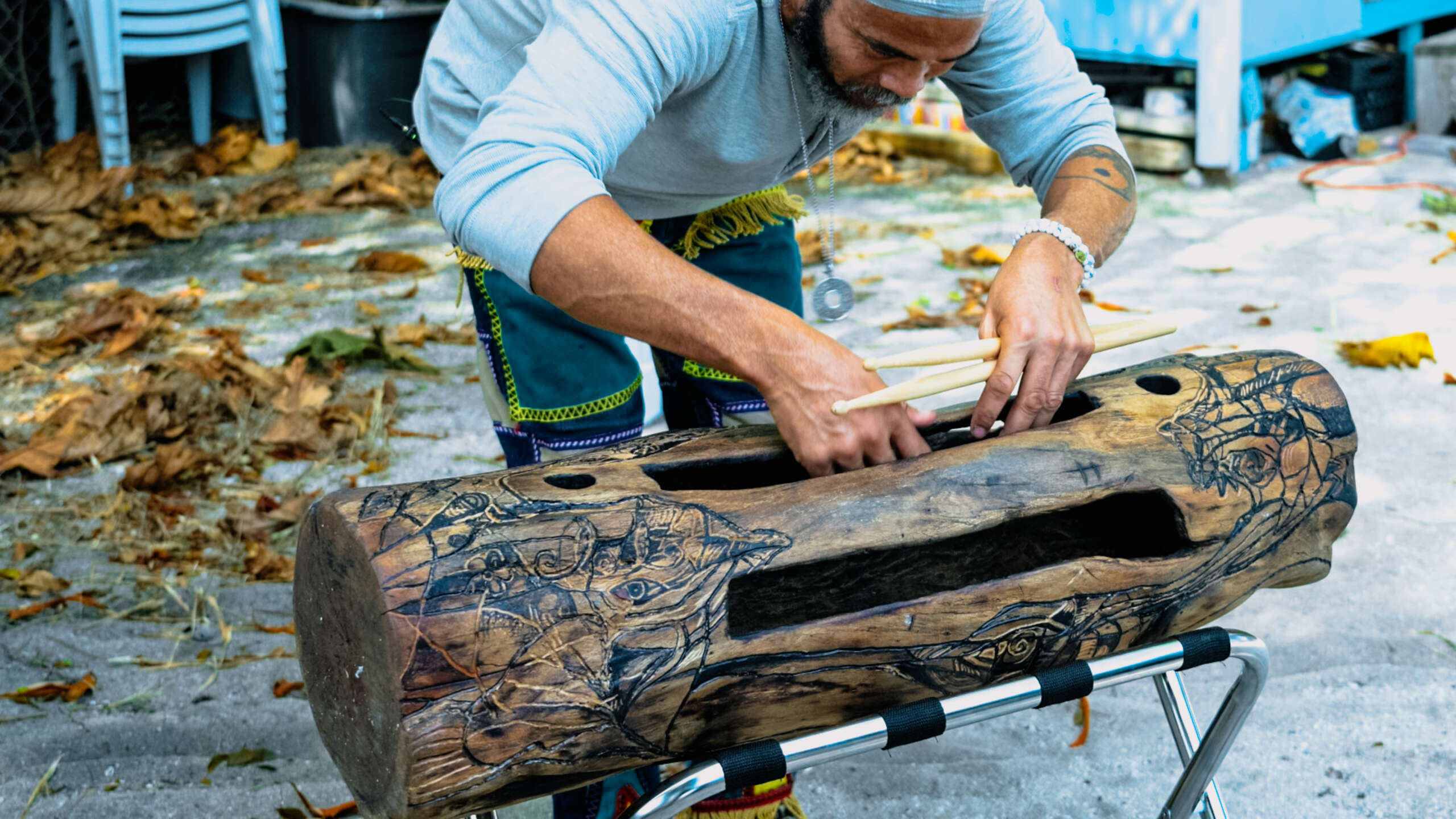 Randy Chollette explains the intricate carving experience of making the drum. - Photo: Taneos Ramsay