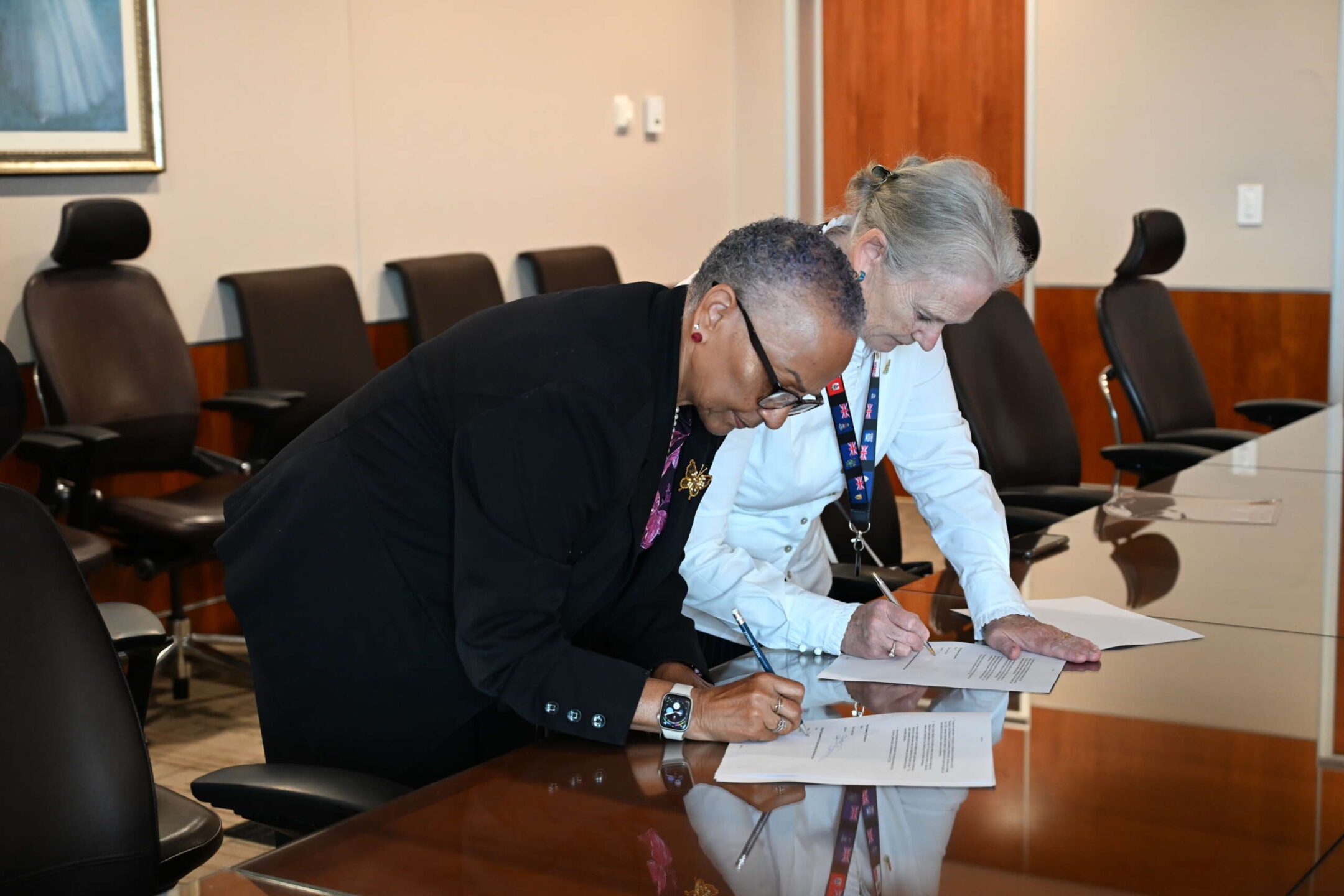 Governor Jane Owen, right, and lead election and referendum observer Deborah Ebanks sign the 2025 Domestic Election and Referendum Observer Mission Terms of Reference in April. - Photo: Supplied
