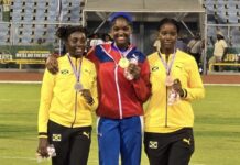 Kaliah Haye makes history at CARIFTA Games Kaliah Haye beams with joy while receiving her historic gold medal at the CARIFTA Games. - Photo: Submitted