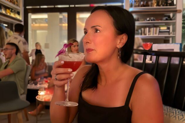 A guest enjoying a cocktail inspired by the art on display