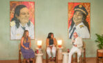 The story behind the pilot paintings at Hotel Indigo From left, artist Cera-Tan Kennaird with Cayman Airways First Officer Giselah Ebanks and Hotel Indigo Grand Cayman Director of Marketing Chris Taylor - Photo: Supplied