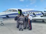 Cayman police deployed to Anguilla amid rising gang violence Cayman police officers having a word of prayer for protection before boarding the plane for Anguilla. - Photo: Supplied