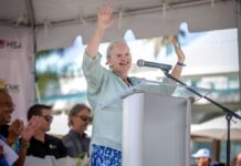 Governor Jane Owen completes her first Flowers Sea Swim Governor Jane Owen addressing the crowd of swimmers and supporters at the race finish. - Photo: Shankar Ebanks