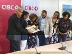 CIBC relaunches ‘Unsung Heroes’ initiative across the Caribbean CIBC executives and managers look at the coffee table book 'Unsung Heroes of the Caribbean', featuring past winners of the bank’s Unsung Heroes programme. - Photo: Supplied