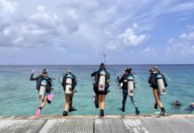 In photos: Women’s Dive Day Divers jump into the water off the pier at Lighthouse Point in West Bay for Women's Dive Day. - Photo: Lisa Collins, Cayman Capture Ltd.