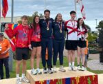 More squash and swimming wins for Cayman at Island Games Cameron Stafford and Jade Pitcairn, centre, after winning gold for Cayman in the mixed doubles squash. - Photo: Lindsey Turnbull
