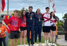 More squash and swimming wins for Cayman at Island Games Cameron Stafford and Jade Pitcairn, centre, after winning gold for Cayman in the mixed doubles squash. - Photo: Lindsey Turnbull
