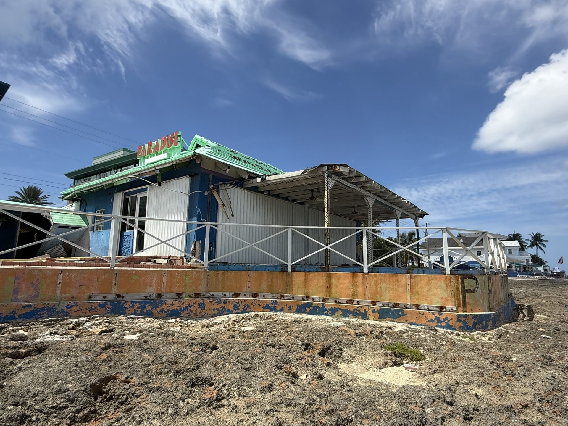 Paradise Bar and Grill is located close to the ironshore. In the background is Eden Rock shop and dive site