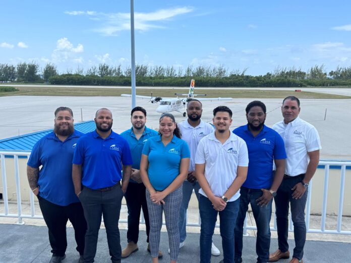 CIAA air trafffic officers Front row, from left, new air traffic control officers Stephen Ebanks, Lauryn Bennette and Jose Delgado, along with, back row from left, Charles Kirkconnell International Airport's Joshua Burke, Rodney Dixon, Eric Bodden and Perry Norris, and Civil Aviation Authority Cayman Islands air navigation services inspector Rob Harris - Photo: Submitted