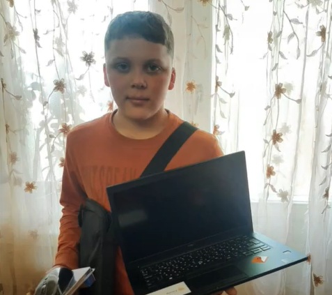Ukrainian child with donated laptop