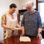 Mary Evelyn Wood’s handiwork acquired by National Museum From left, Joy Basdeo hands over two hand-crafted handbags that belonged to National Hero Mary Evelyn Wood to the National Museum. - Photo: The Cayman Islands National Museum