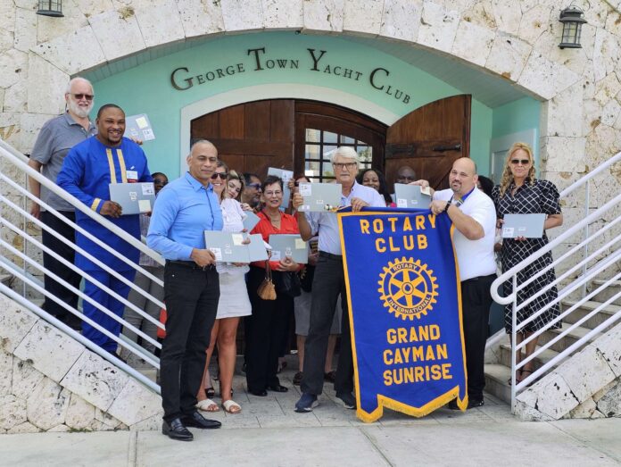 Rotary Club Grand Cayman Sunrise with donated laptops