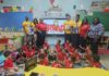 UCCI visits schools to promote reading on International Literacy Day UCCI representatives along with students and faculty of Sir John A Cumber Primary School during their visit to the school to promote International Literacy Day on 8 Sept. - Photo: Supplied