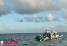 Coast Guard rescues three from sinking boat in North Sound Cayman Islands Coast Guard was able to tow the boat back to land.