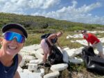 Scuba volunteers remove polystyrene debris from shoreline