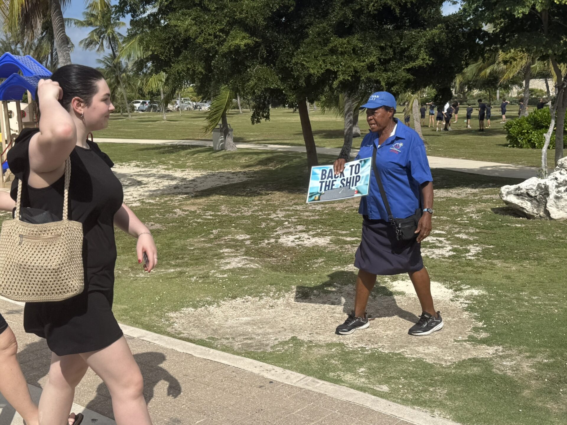 A tourist is guided to the waiting taxis to take her back to her cruise ship
