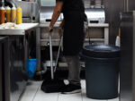 MP warns about ‘unintended consequence’ of minimum wage Restaurant kitchen employee sweeping the floor