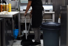 MP warns about ‘unintended consequence’ of minimum wage Restaurant kitchen employee sweeping the floor