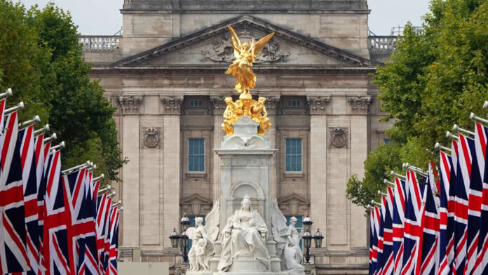 London, UK - September 14, 2022: A view along the Mall lined with British flags towards Buckingham Palace and the Victoria Memorial in London, UK.