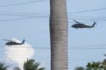Three US Blackhawk helicopters refuel in Grand Cayman